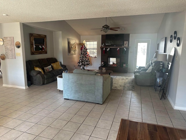 living room with plenty of natural light, light tile patterned floors, a textured ceiling, and lofted ceiling