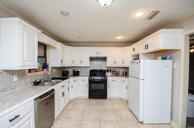 kitchen featuring black gas range, sink, stainless steel dishwasher, white refrigerator, and backsplash