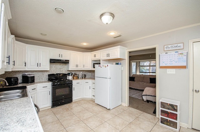 kitchen featuring black range with gas stovetop, white refrigerator, white cabinetry, and crown molding