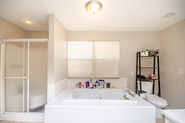 full bathroom with a textured ceiling, vanity, toilet, and independent shower and bath