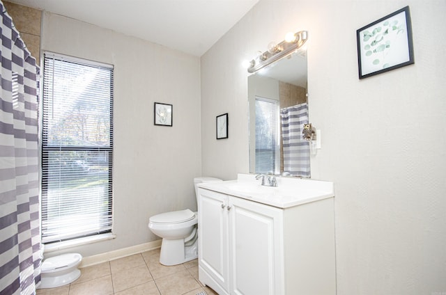 bathroom with tile patterned flooring, vanity, and toilet