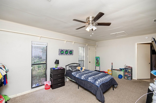 bedroom featuring carpet, ceiling fan, and multiple windows