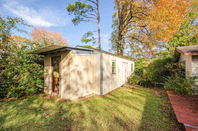 view of outbuilding featuring a yard