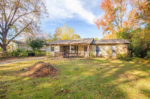 rear view of property featuring a lawn