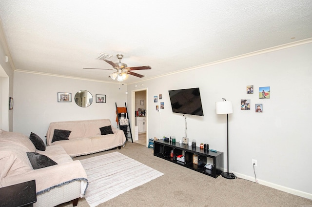 carpeted living room featuring ceiling fan, a textured ceiling, and ornamental molding