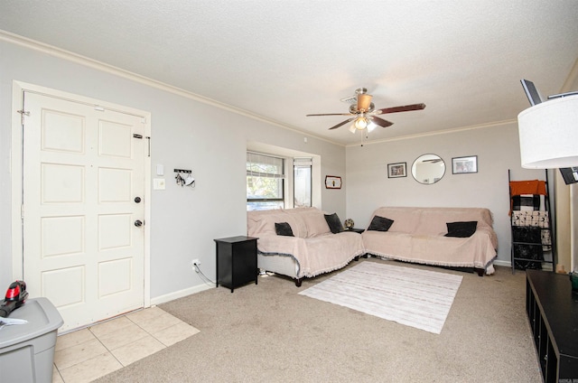 living room with a textured ceiling, ceiling fan, ornamental molding, and light carpet