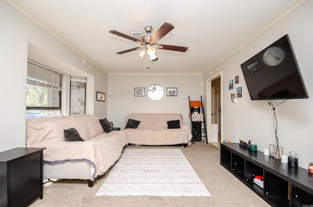 living room featuring crown molding, ceiling fan, light colored carpet, and a textured ceiling