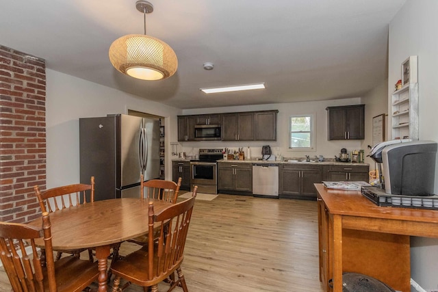 dining space with light hardwood / wood-style floors and sink