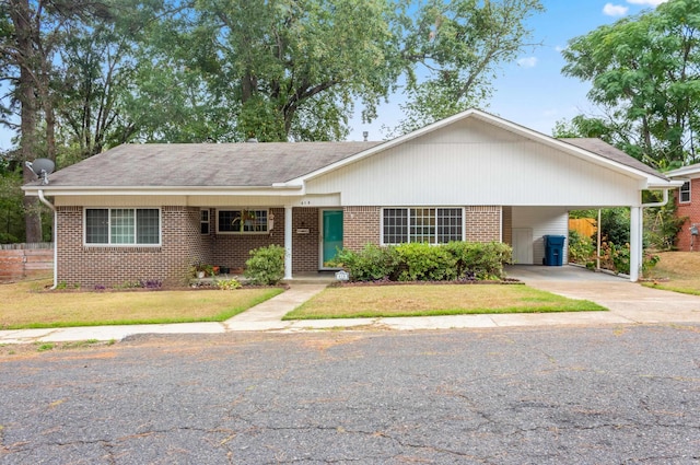 ranch-style home featuring a carport and a front yard