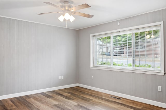 unfurnished room with wood-type flooring, plenty of natural light, ornamental molding, and ceiling fan