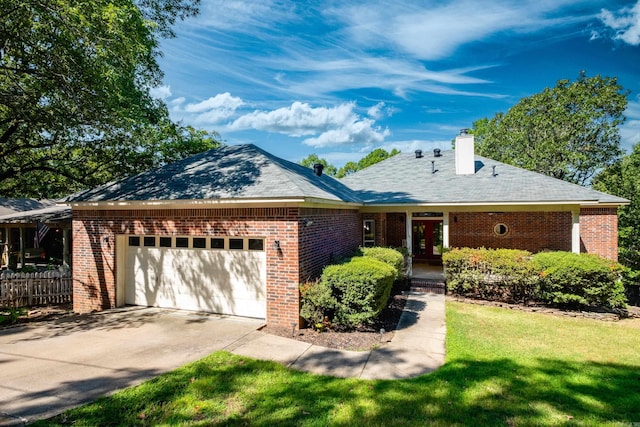 ranch-style house featuring a garage and a front yard