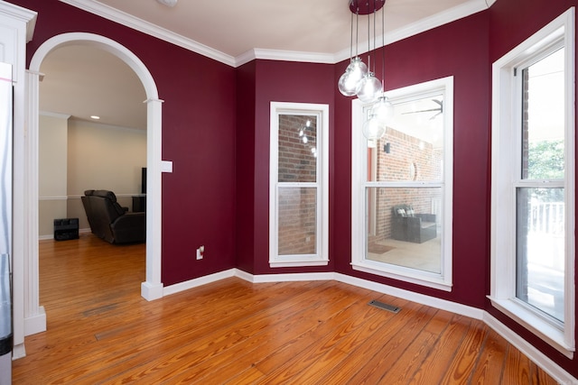 unfurnished dining area with wood-type flooring and ornamental molding