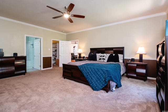 bedroom featuring ceiling fan, light colored carpet, a spacious closet, and ornamental molding