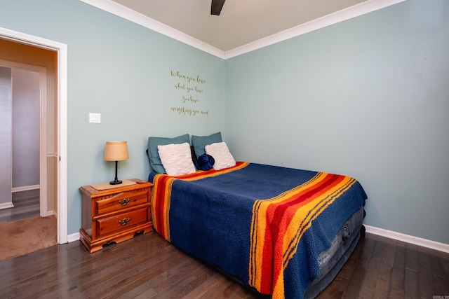 bedroom featuring dark hardwood / wood-style floors, ceiling fan, and ornamental molding