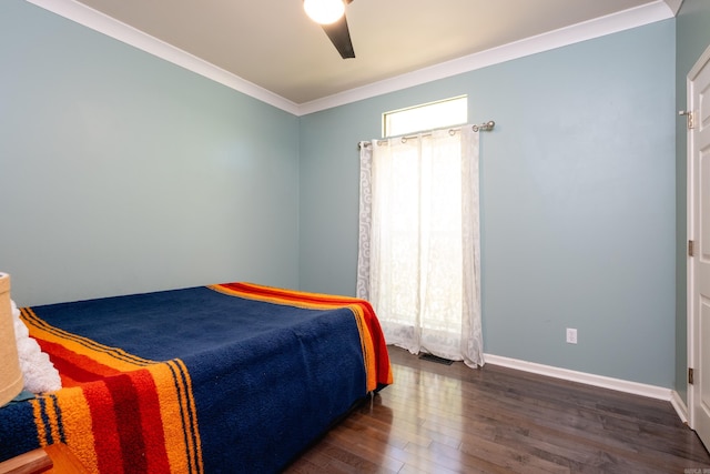 bedroom with dark hardwood / wood-style floors, ceiling fan, and ornamental molding