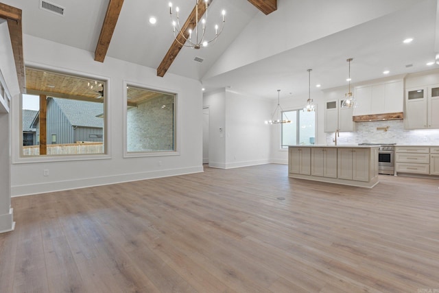 kitchen with decorative light fixtures, light hardwood / wood-style flooring, beamed ceiling, a large island, and stainless steel range oven