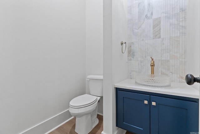 bathroom featuring vanity, hardwood / wood-style flooring, and toilet