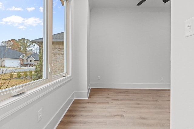 empty room with crown molding, light hardwood / wood-style flooring, and ceiling fan