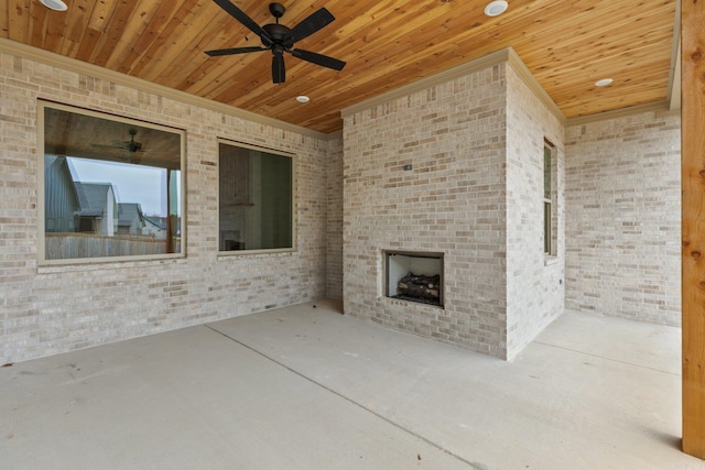 view of patio / terrace with ceiling fan and an outdoor fireplace