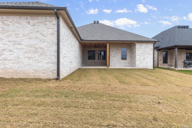 rear view of property featuring a yard