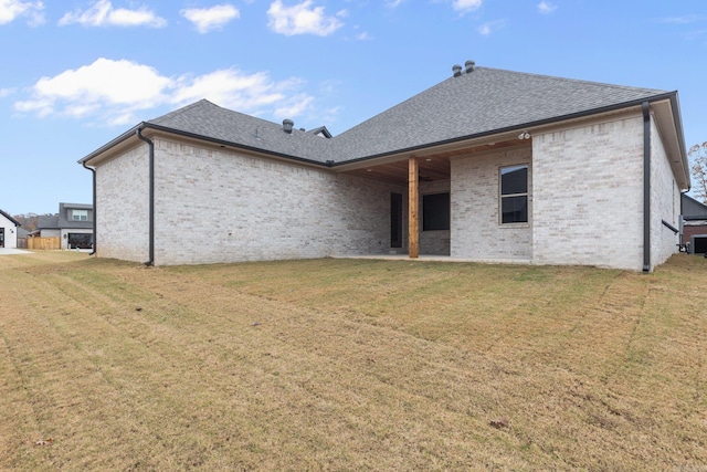 rear view of property featuring a yard