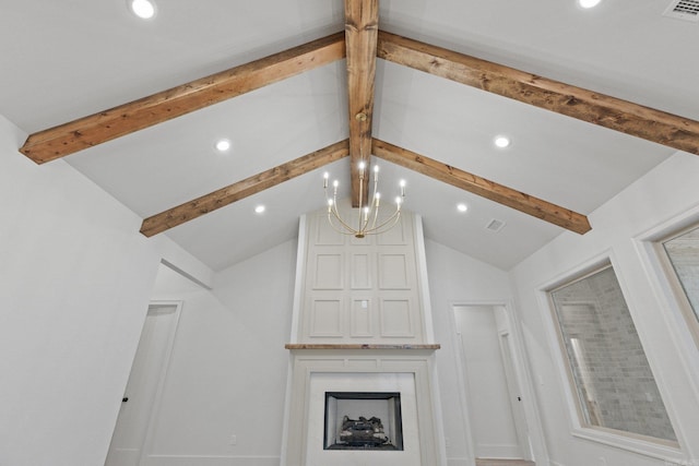 unfurnished living room featuring a chandelier and lofted ceiling with beams