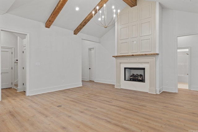 unfurnished living room featuring beamed ceiling, high vaulted ceiling, light hardwood / wood-style floors, and an inviting chandelier