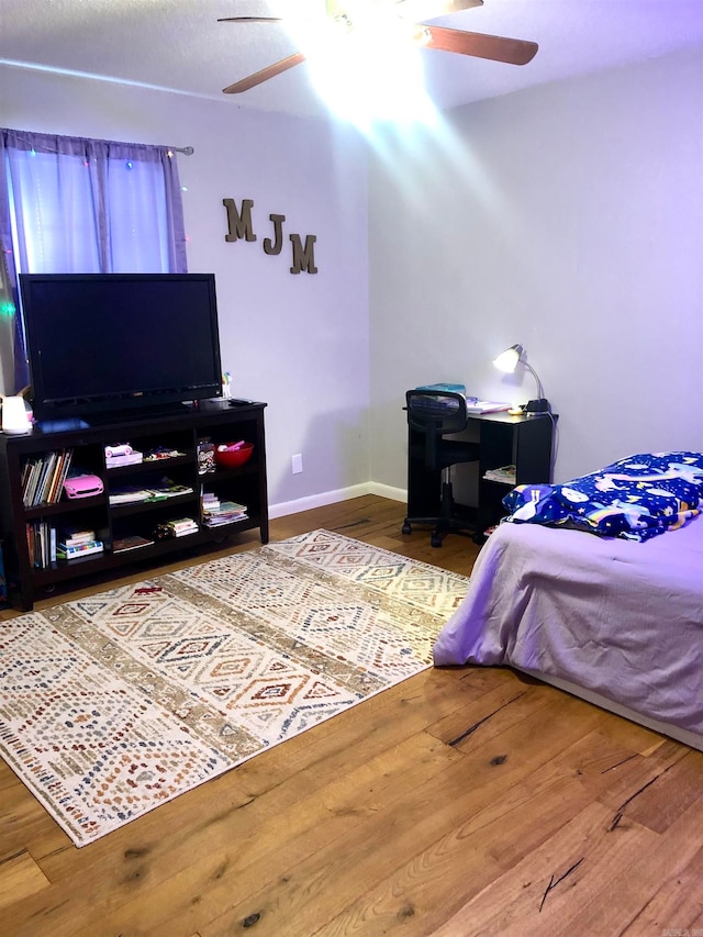 bedroom featuring hardwood / wood-style floors and ceiling fan