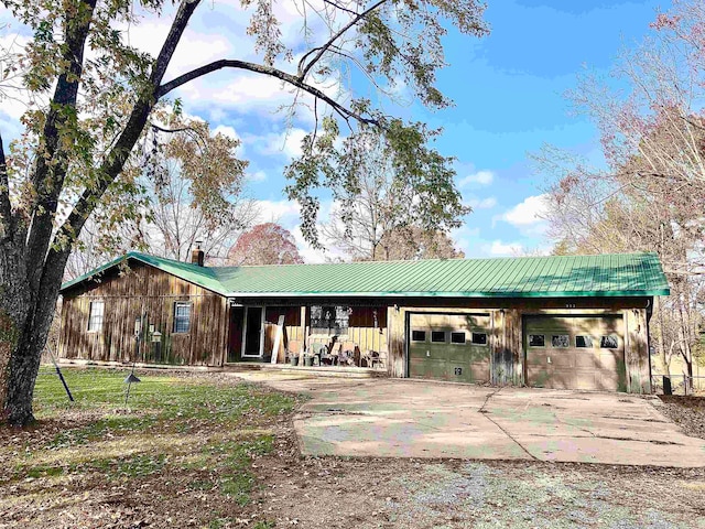 view of front of home with a porch and a garage