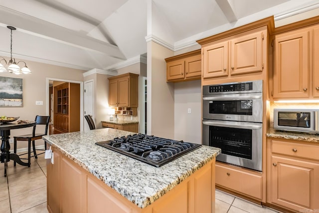 kitchen featuring appliances with stainless steel finishes, light stone counters, light tile patterned floors, a kitchen island, and lofted ceiling