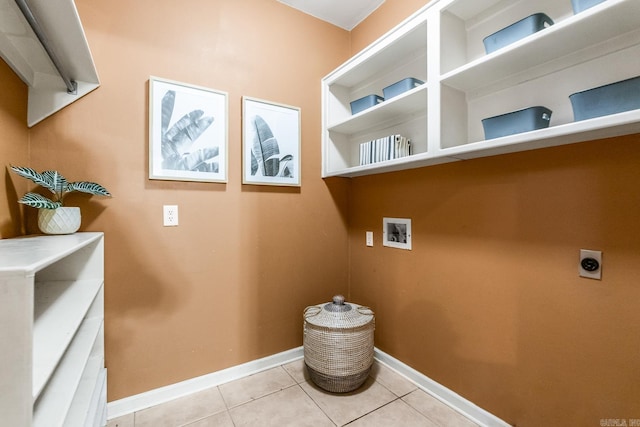 clothes washing area featuring light tile patterned flooring, washer hookup, and hookup for an electric dryer