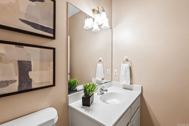 bathroom featuring vanity and toilet