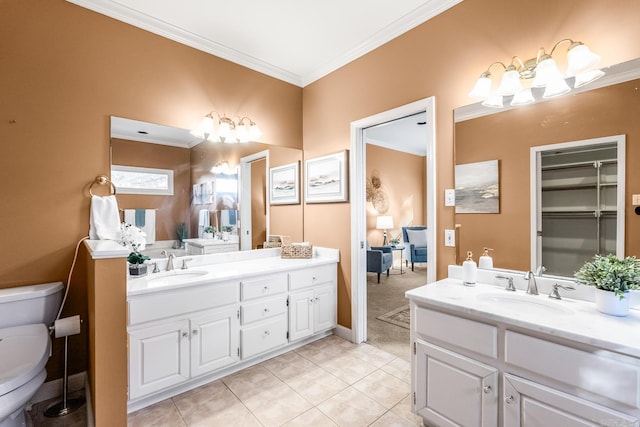 bathroom with tile patterned floors, crown molding, and vanity