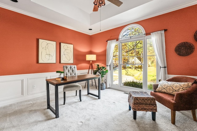 office area featuring light carpet, a raised ceiling, ceiling fan, and crown molding