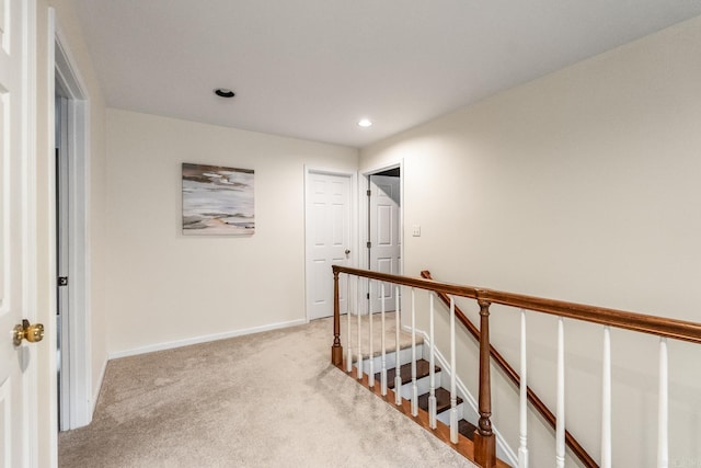 hallway featuring light colored carpet