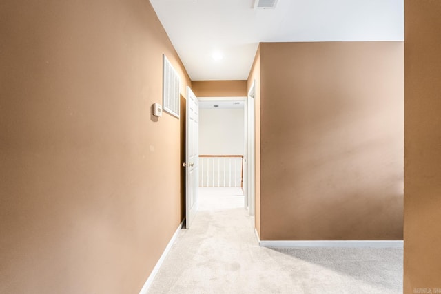 hall featuring light colored carpet