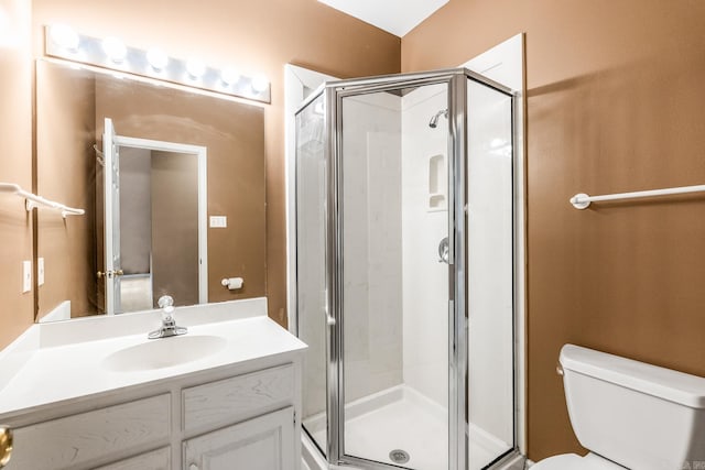 bathroom with vanity, toilet, and walk in shower