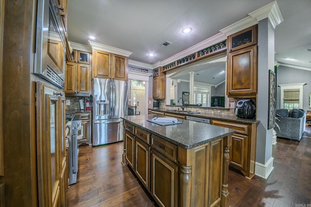 kitchen with backsplash, a center island, lofted ceiling, and appliances with stainless steel finishes