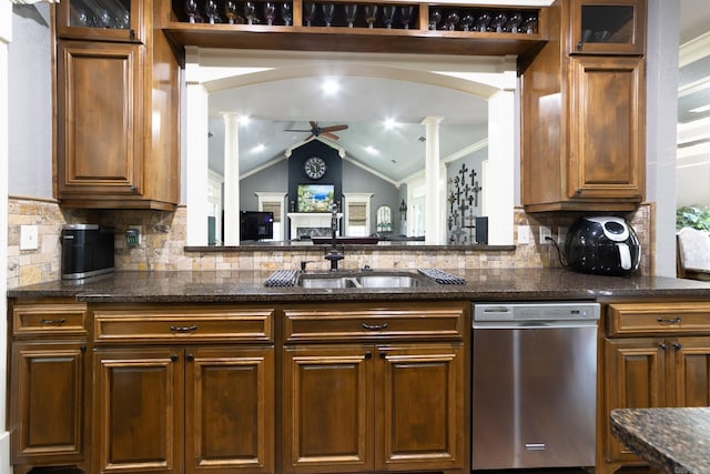 kitchen featuring dishwasher, tasteful backsplash, lofted ceiling, and decorative columns