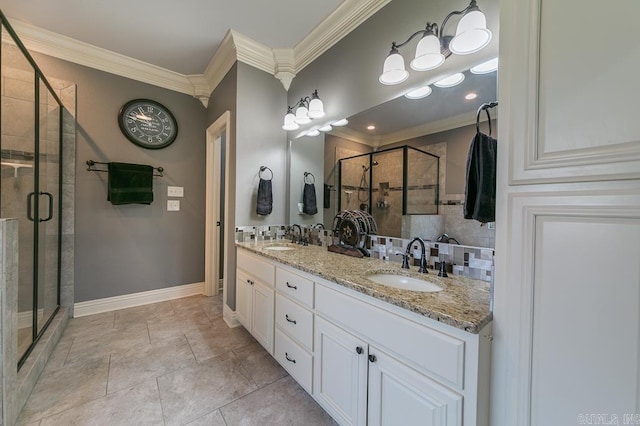 bathroom with vanity, an enclosed shower, and crown molding