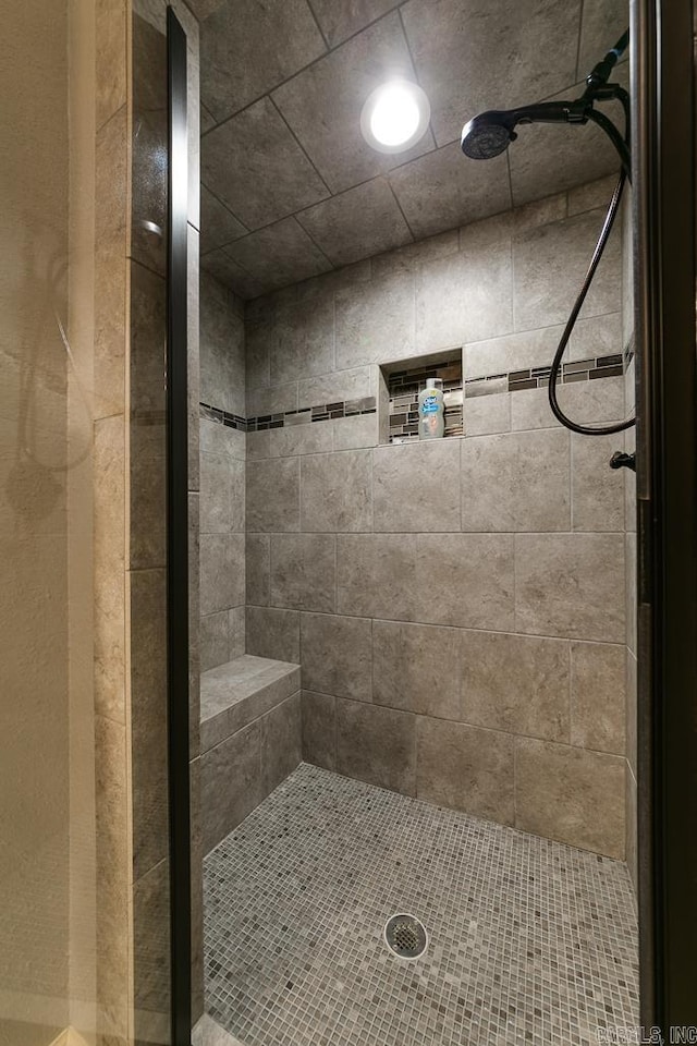 bathroom with tiled shower