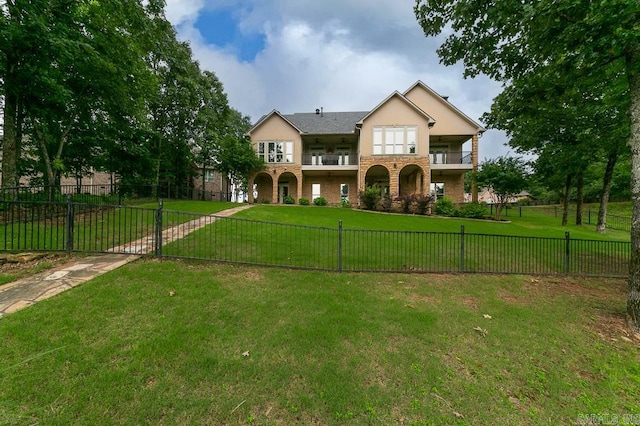 view of front of property with a balcony and a front lawn