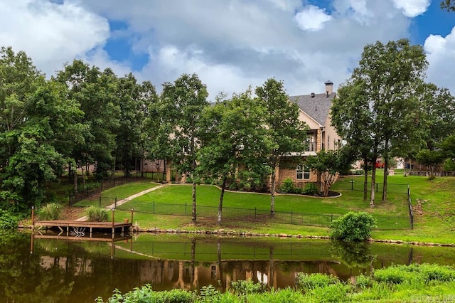 view of community featuring a yard and a water view