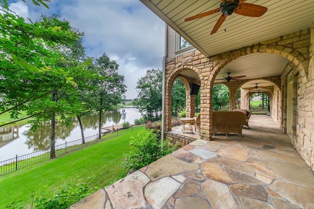 view of patio with ceiling fan, a water view, and an outdoor hangout area