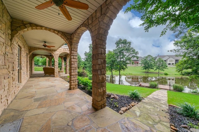 view of patio / terrace with a water view and ceiling fan