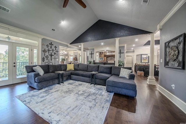 living room with wood-type flooring, decorative columns, vaulted ceiling, and ornamental molding