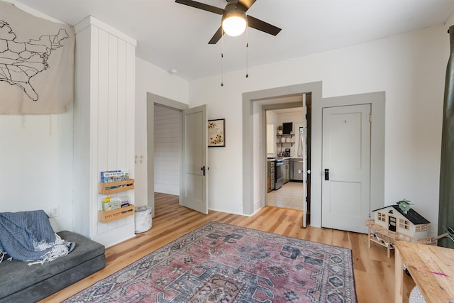 living area featuring hardwood / wood-style floors and ceiling fan