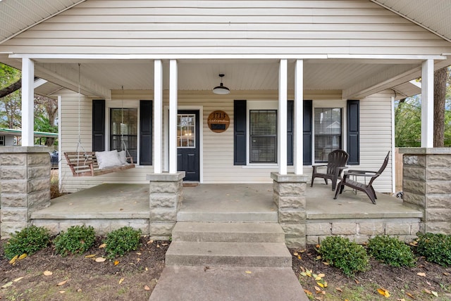 view of exterior entry featuring a porch