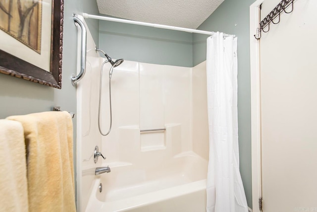 bathroom with a textured ceiling and shower / tub combo with curtain