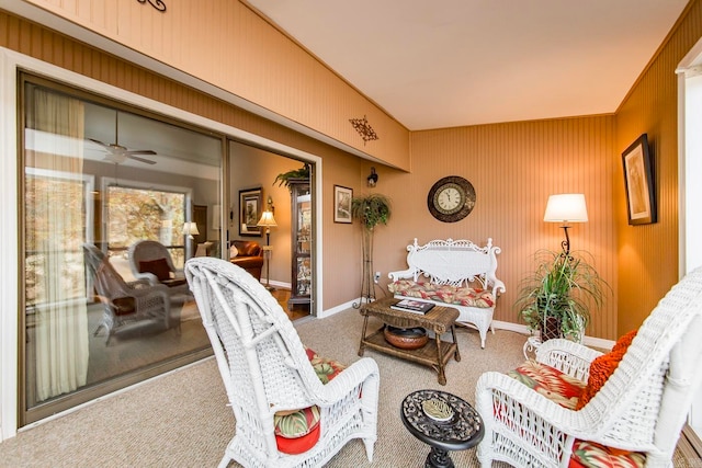 carpeted living room featuring ceiling fan